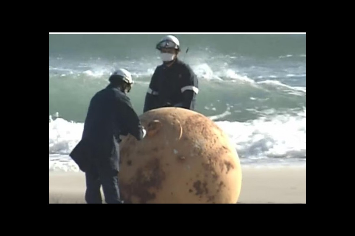 Japan. A mysterious metallic sphere appears on the beach