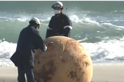 Japan. A mysterious metallic sphere appears on the beach