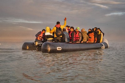 A boat with 50 migrants sinks in waters off northern France and some are in critical condition