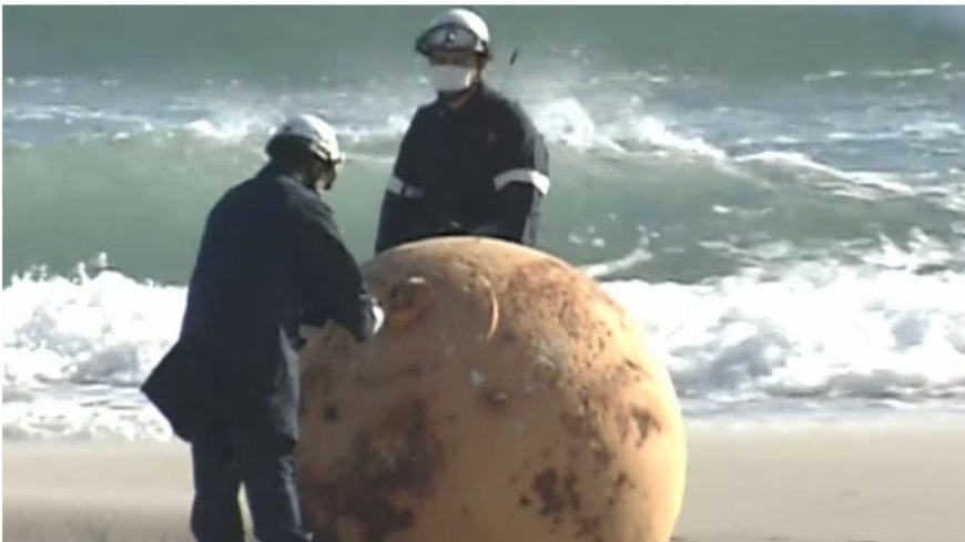 Japan. A mysterious metallic sphere appears on the beach